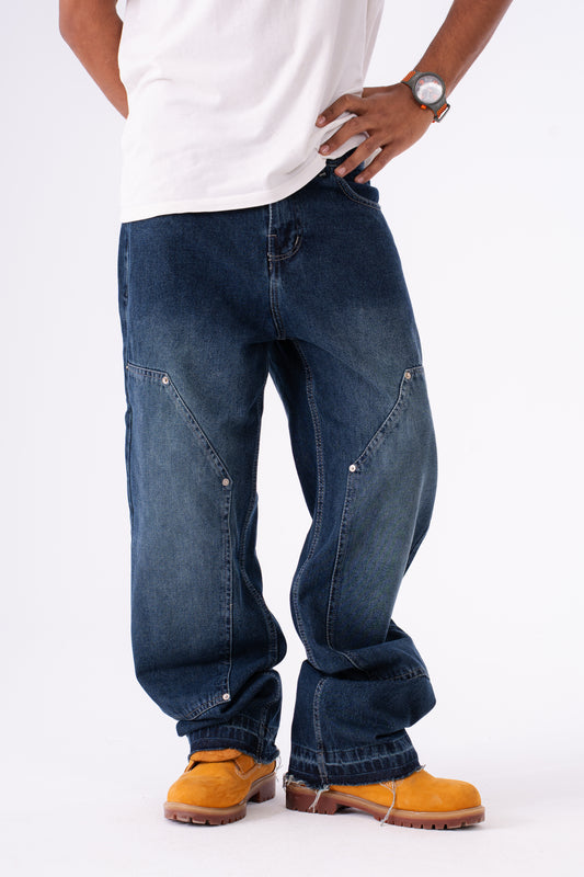 Person wearing blue baggy jeans on a white background