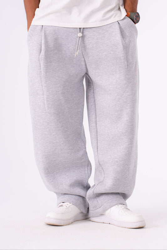Person wearing gray sweatpants on a white background