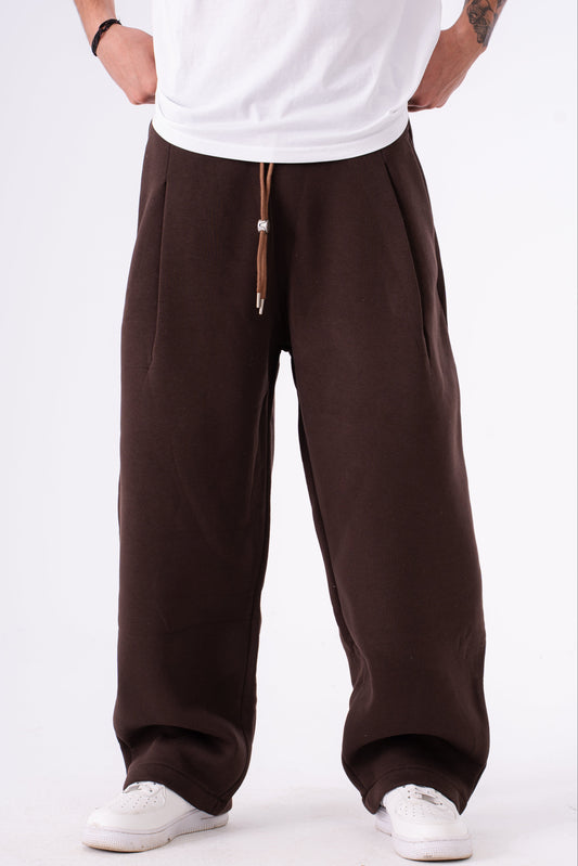 Person wearing brown sweatpants on a white background