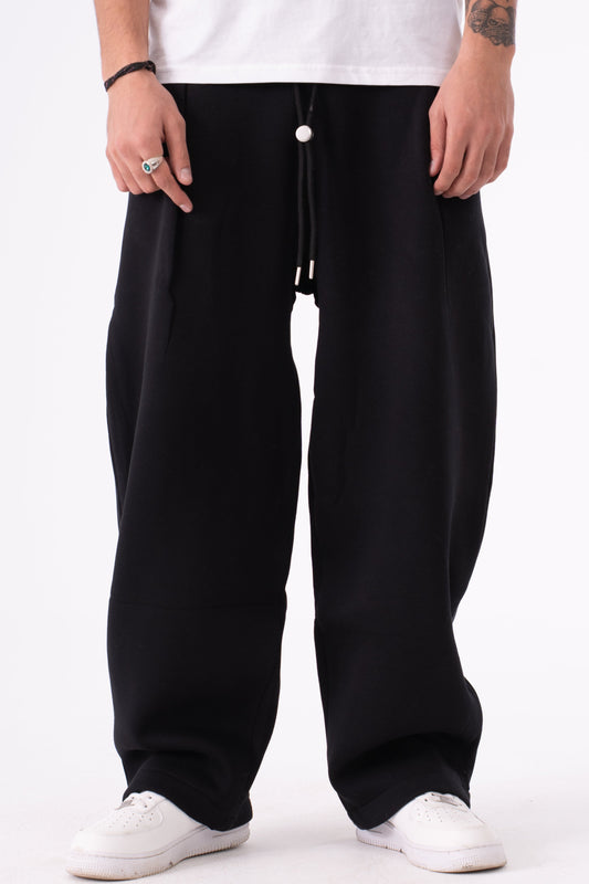 Person wearing black sweatpants on a white background
