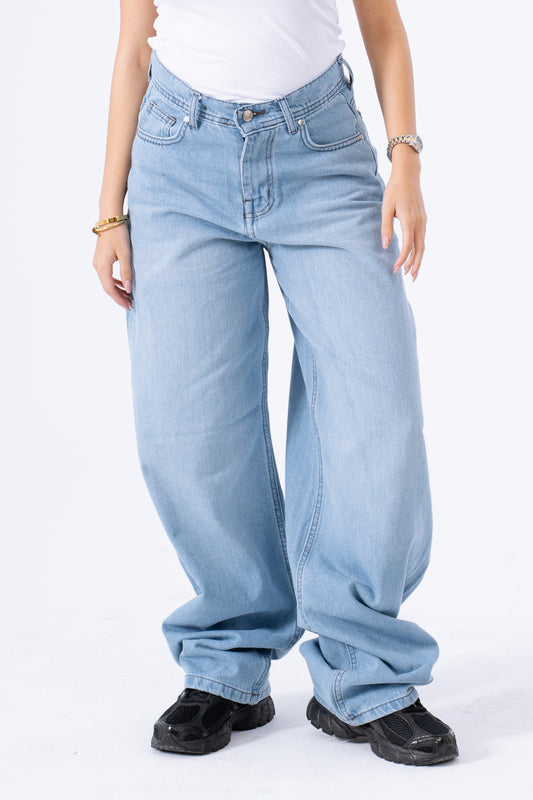 Light blue jeans worn by a person on a white background