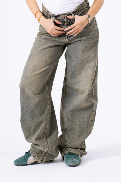 Person wearing baggy jeans on a white background