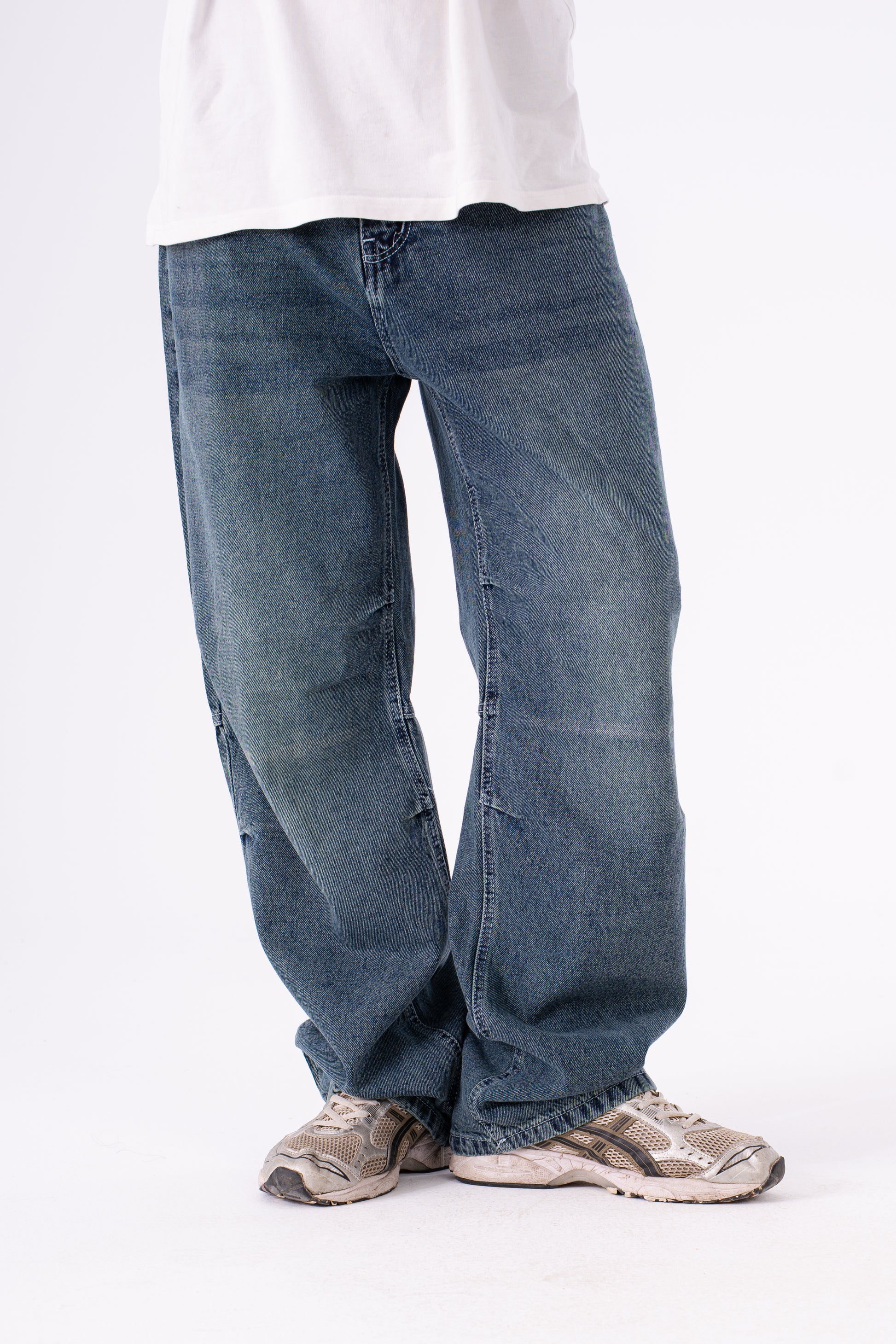 Blue jeans worn by a person on a white background