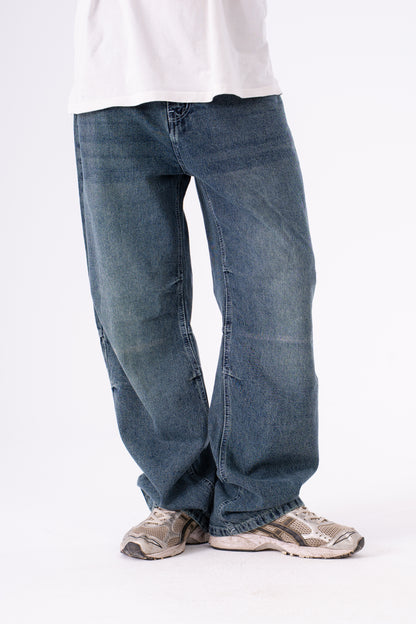 Blue jeans worn by a person on a white background