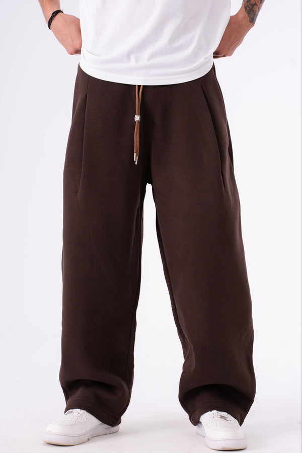 Person wearing brown sweatpants  on a white background