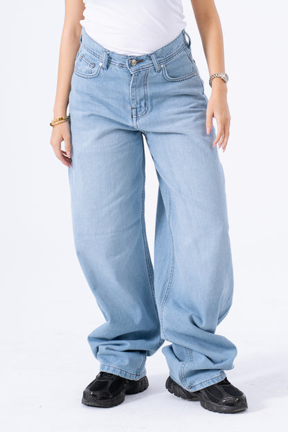 Light blue jeans worn by a person on a white background